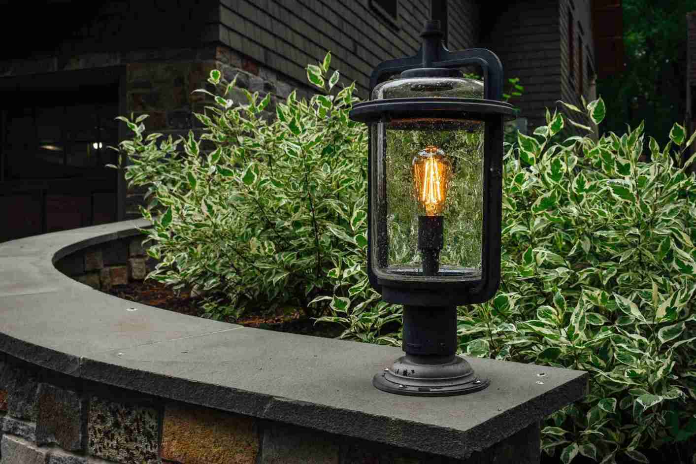 Low-voltage pathway lights illuminating a garden walkway at dusk