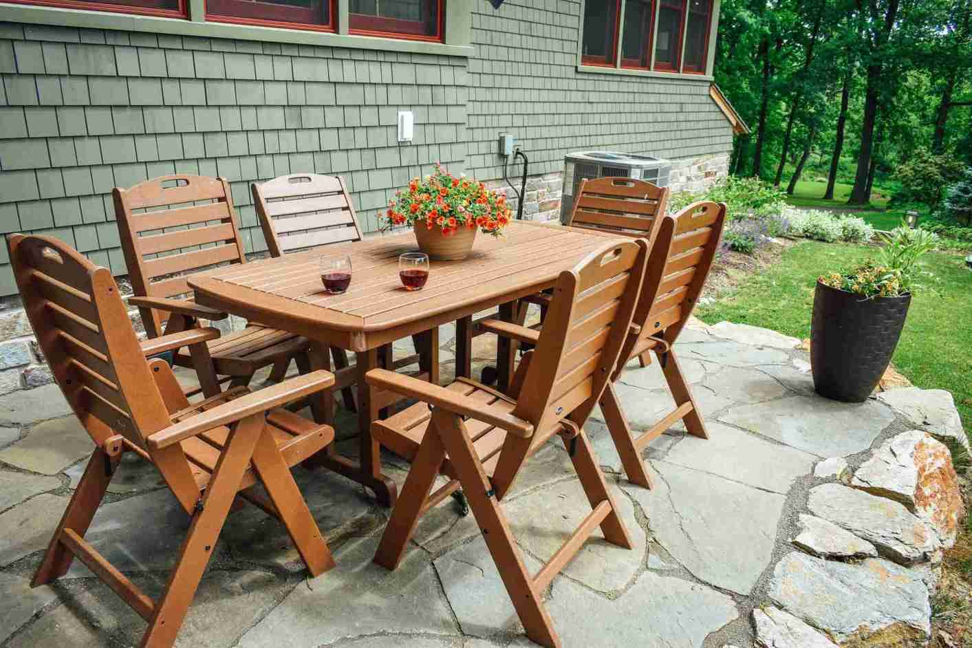 Wooden dining set on flagstone patio